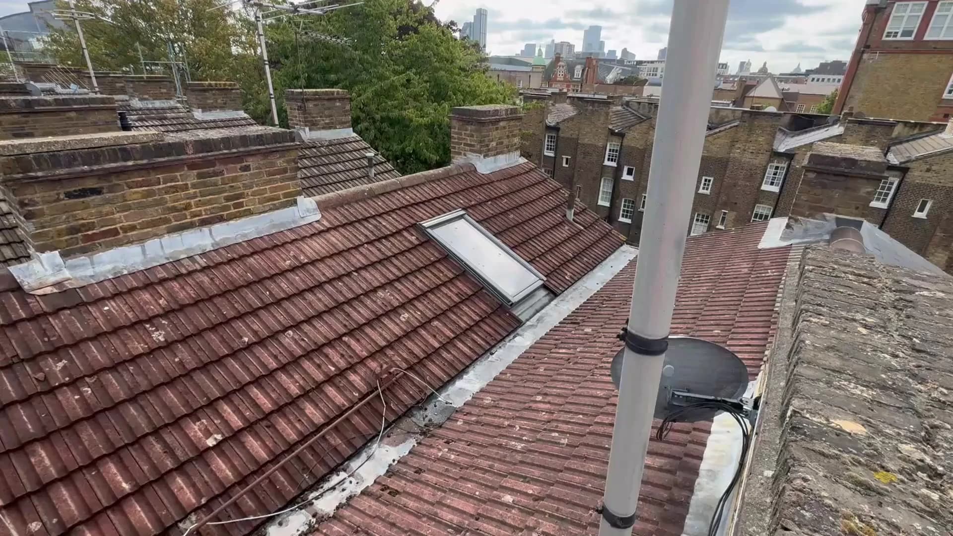 Concrete-tiled butterfly roof and parapet walls surveyed in Farringdon