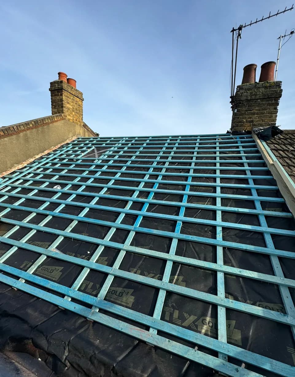 Pitched roof insulation installed between rafters beneath the battens