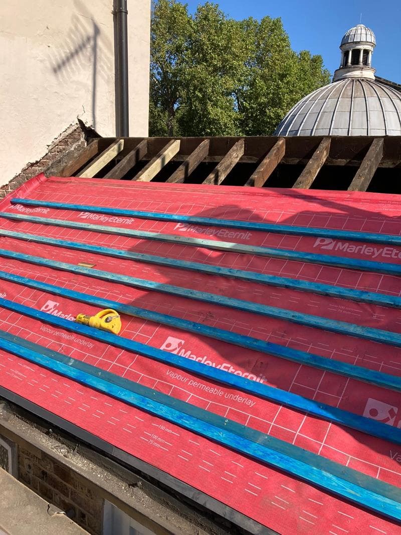 A completed London roof protecting the building beneath it