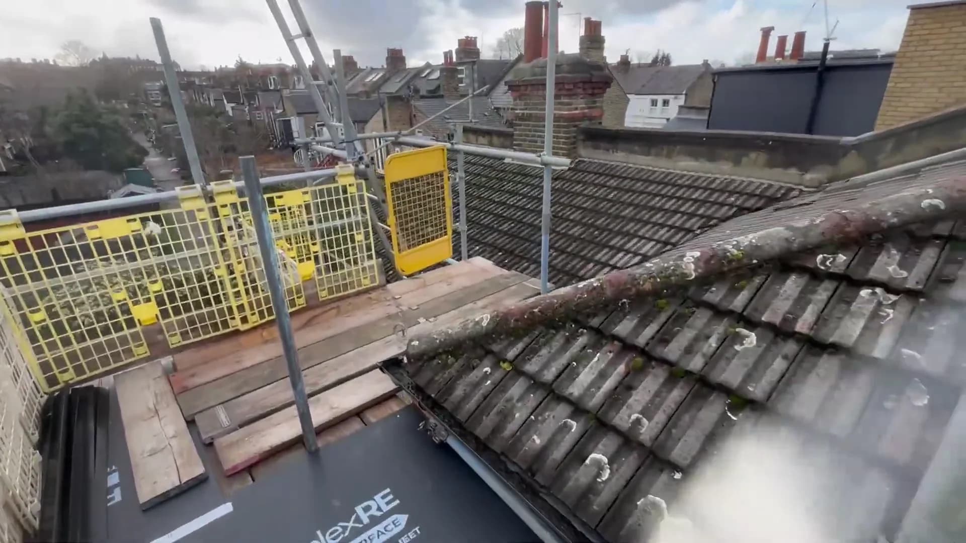 Old concrete tiles on the Vauxhall pitched roof before replacement